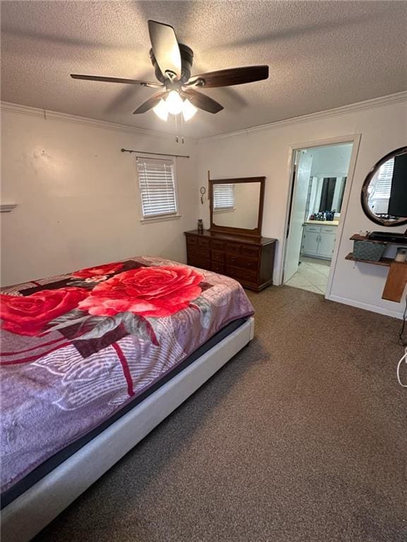 carpeted bedroom featuring crown molding, ceiling fan, ensuite bathroom, and a textured ceiling