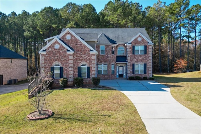 view of front of property featuring cooling unit and a front lawn