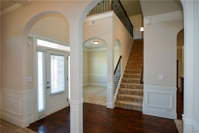 foyer entrance featuring dark hardwood / wood-style flooring and ornamental molding