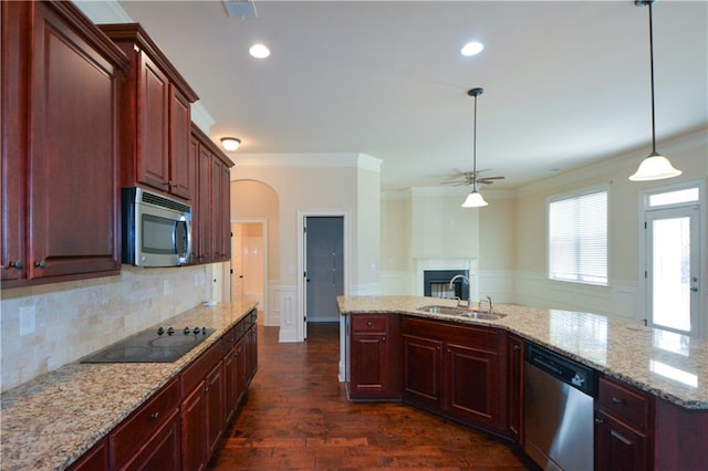 kitchen with pendant lighting, dark wood-type flooring, sink, crown molding, and appliances with stainless steel finishes