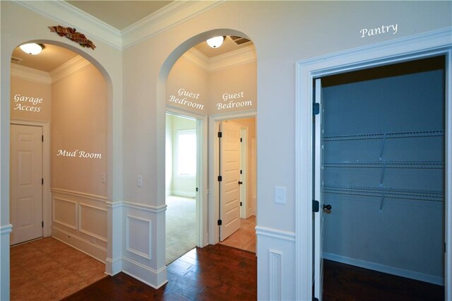 hall featuring crown molding and dark wood-type flooring