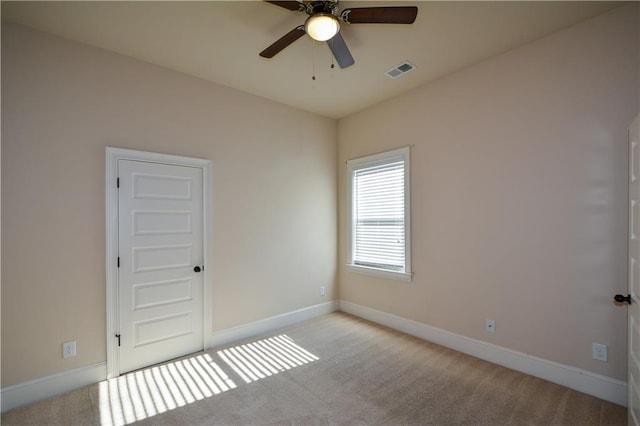 carpeted spare room with ceiling fan