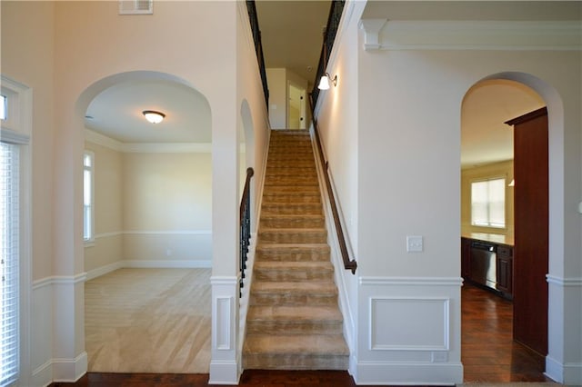 stairway featuring carpet floors and ornamental molding