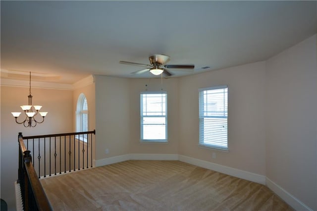 unfurnished room with carpet and ceiling fan with notable chandelier