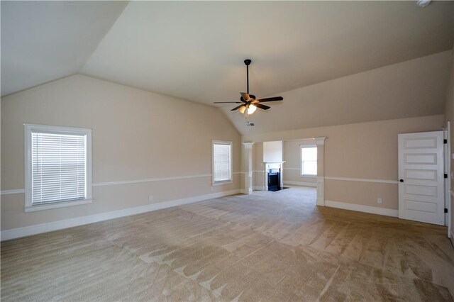 unfurnished living room featuring light carpet, ceiling fan, and vaulted ceiling