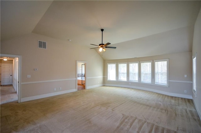 unfurnished living room featuring ceiling fan, high vaulted ceiling, and light colored carpet