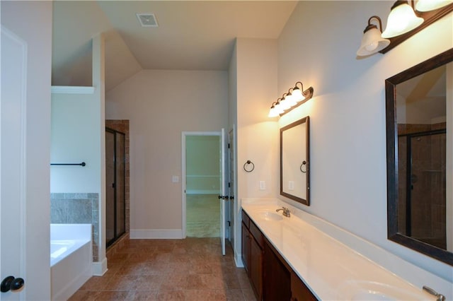 bathroom featuring tile patterned flooring, vanity, plus walk in shower, and vaulted ceiling