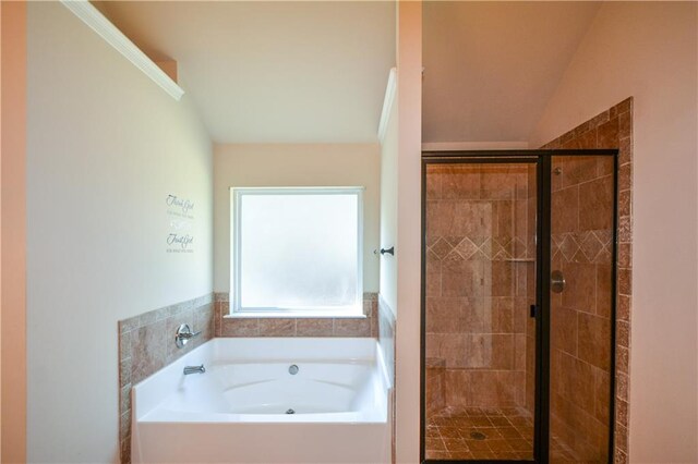 bathroom featuring plus walk in shower and lofted ceiling