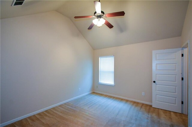 unfurnished room featuring light colored carpet, ceiling fan, and lofted ceiling