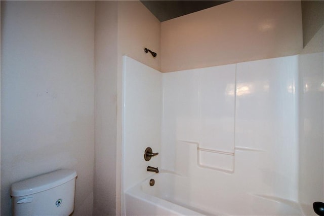 bathroom with tub / shower combination and toilet