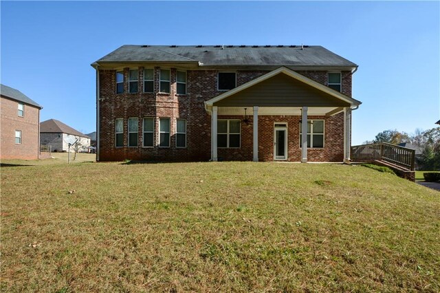 back of house featuring a yard