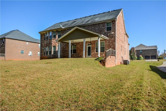 rear view of property featuring a yard and cooling unit