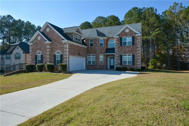 view of front of property featuring a front yard and a garage