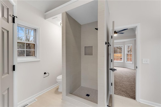 full bathroom featuring a wealth of natural light, visible vents, a shower stall, and toilet