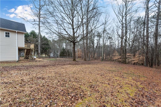 view of yard featuring stairs and a wooden deck