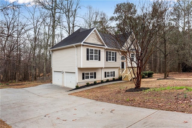 view of front of house featuring concrete driveway and an attached garage