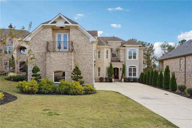 3423 Jamont Blvd, Alpharetta, GA 30022 - view of front of home with a balcony, a front yard, and driveway