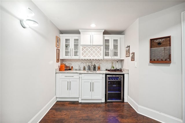 3423 Jamont Blvd, Alpharetta, GA 30022 - indoor wet bar featuring beverage cooler, decorative backsplash, dark wood finished floors, baseboards, and recessed lighting