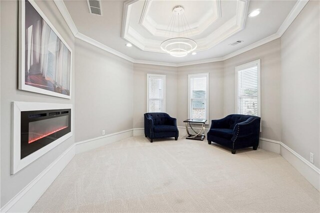 3423 Jamont Blvd, Alpharetta, GA 30022 - sitting room with ornamental molding, carpet flooring, a tray ceiling, a glass covered fireplace, and a chandelier