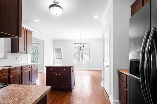 1433 Sand Way, Lawrenceville, GA 30045 - kitchen featuring refrigerator with ice dispenser, crown molding, plenty of natural light, dark wood finished floors, and tasteful backsplash