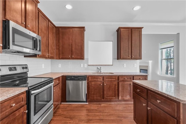 1433 Sand Way, Lawrenceville, GA 30045 - kitchen with appliances with stainless steel finishes, a sink, ornamental molding, dark wood-type flooring, and backsplash