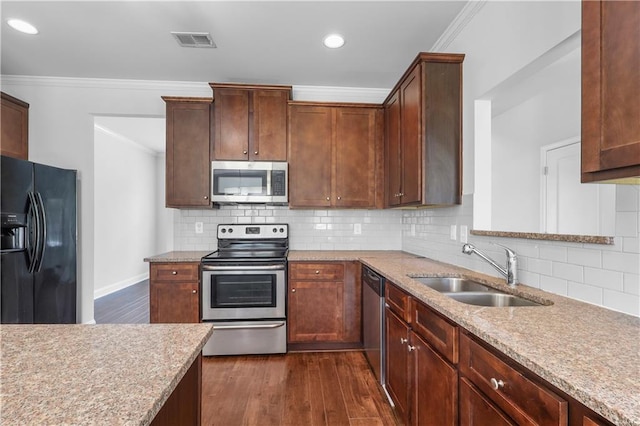 1433 Sand Way, Lawrenceville, GA 30045 - kitchen featuring stainless steel appliances, a sink, ornamental molding, dark wood finished floors, and light stone countertops