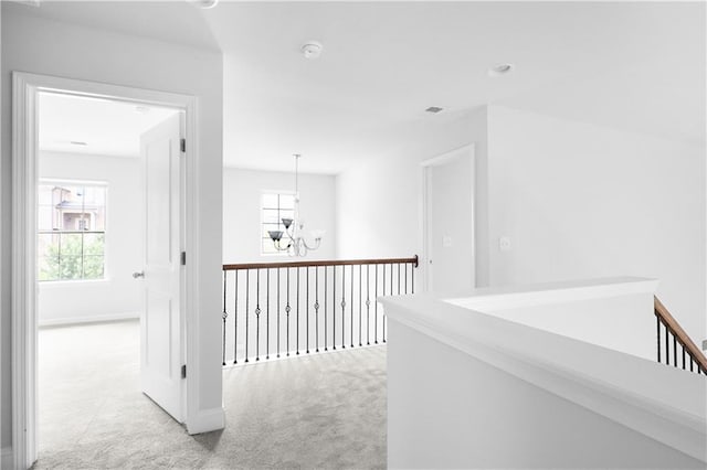 1433 Sand Way, Lawrenceville, GA 30045 - hall with light colored carpet, a chandelier, healthy amount of natural light, and baseboards