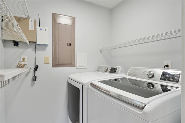 washroom featuring washing machine and clothes dryer and electric panel