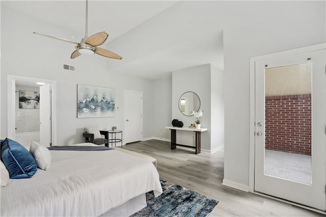 bedroom featuring ceiling fan, ensuite bath, high vaulted ceiling, and light hardwood / wood-style flooring