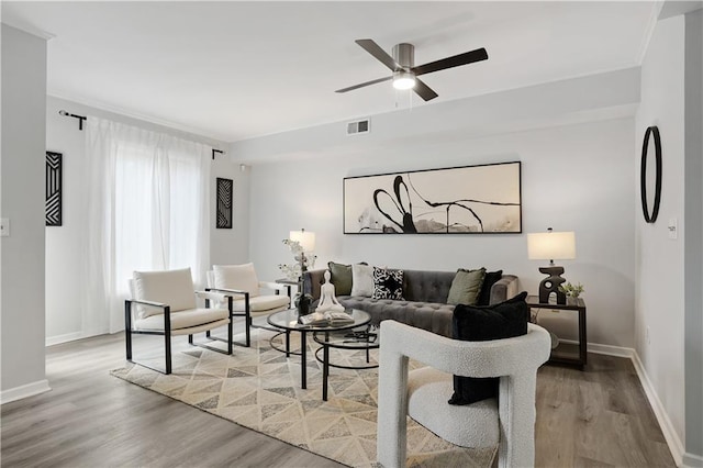 living room with ceiling fan and wood-type flooring