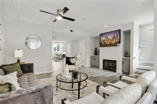 living room featuring ceiling fan and light hardwood / wood-style floors