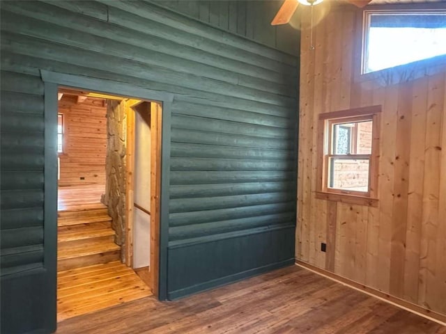 68 Star Lake Ln, Sautee Nacoochee, GA 30571 - entrance foyer featuring log walls, wood finished floors, a ceiling fan, and stairway