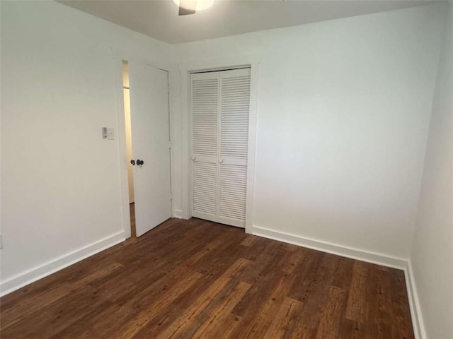 68 Star Lake Ln, Sautee Nacoochee, GA 30571 - unfurnished bedroom with dark wood-style flooring, a closet, baseboards, and a ceiling fan