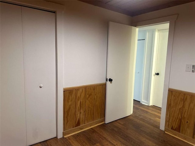 68 Star Lake Ln, Sautee Nacoochee, GA 30571 - unfurnished bedroom with wainscoting, wood finished floors, wood walls, and a closet