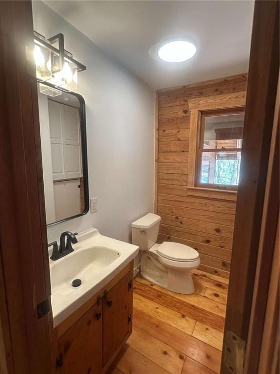 68 Star Lake Ln, Sautee Nacoochee, GA 30571 - half bathroom featuring toilet, wooden walls, vanity, and wood finished floors