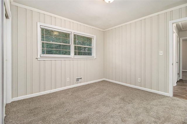 empty room with carpet flooring and ornamental molding