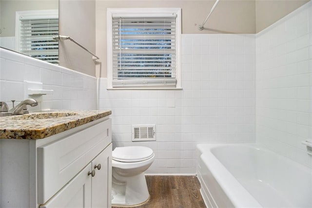 full bathroom with toilet, vanity, tile walls, and hardwood / wood-style flooring