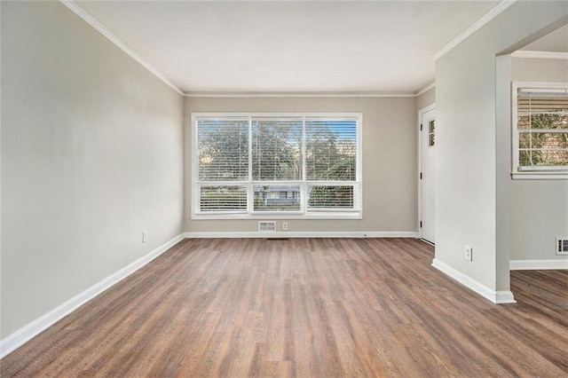 empty room featuring dark hardwood / wood-style floors and ornamental molding