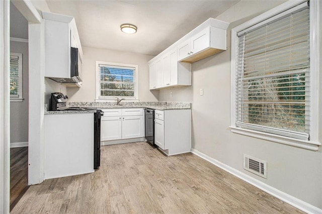 kitchen with black range with electric cooktop, light stone counters, light hardwood / wood-style flooring, crown molding, and white cabinets