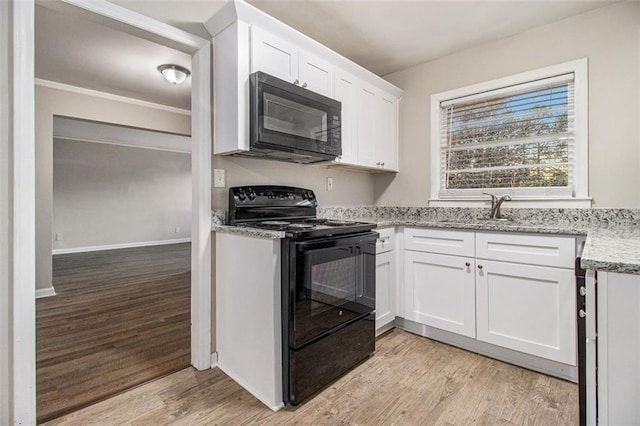 kitchen with white cabinets, light stone counters, light hardwood / wood-style flooring, and black appliances