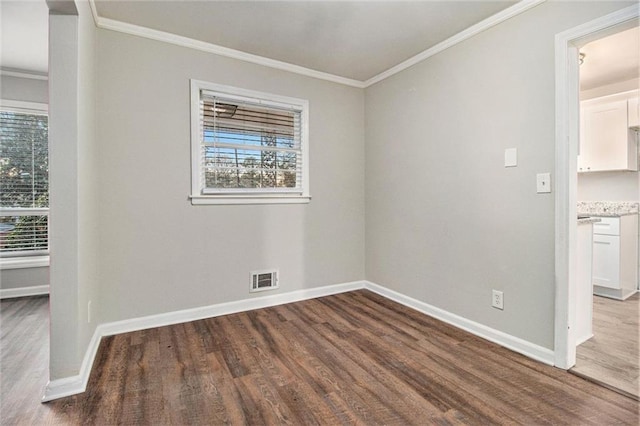 spare room with wood-type flooring and ornamental molding