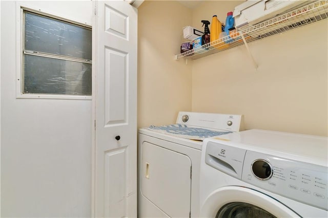 washroom featuring washing machine and dryer