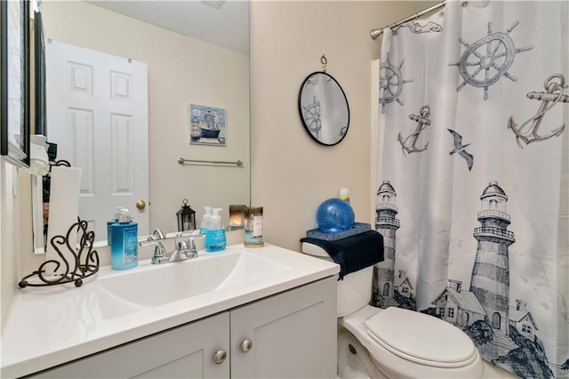 bathroom featuring vanity, curtained shower, and toilet