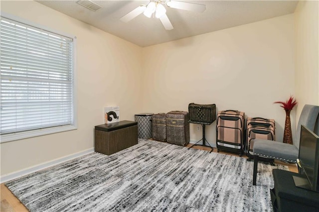 living area with ceiling fan