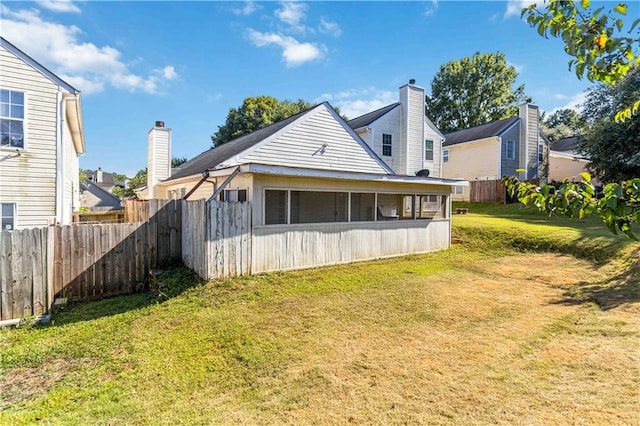 rear view of house with a yard