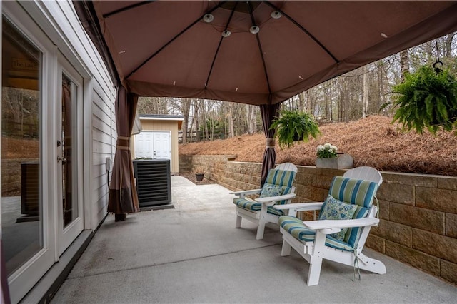 view of patio featuring cooling unit and a gazebo