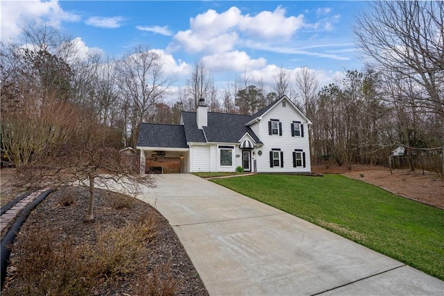 traditional-style home with driveway, a shingled roof, a chimney, and a front lawn