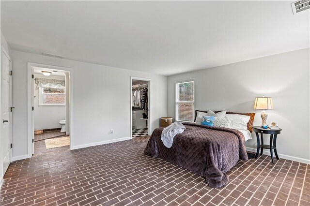 bedroom with baseboards, multiple windows, and visible vents