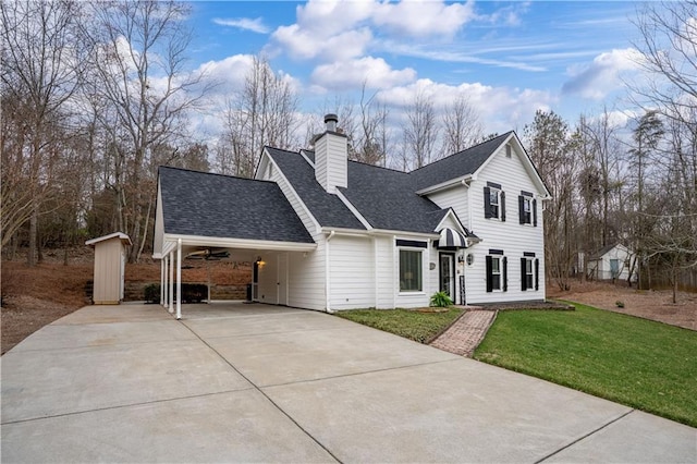 view of front of house featuring a chimney, a front lawn, concrete driveway, and roof with shingles