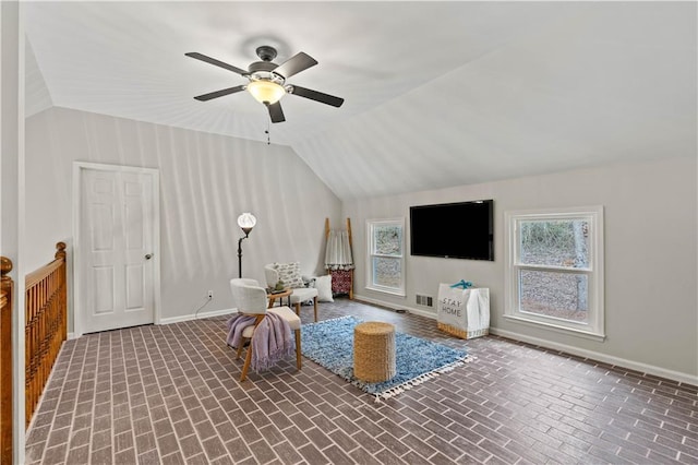 unfurnished room featuring brick floor, visible vents, vaulted ceiling, ceiling fan, and baseboards